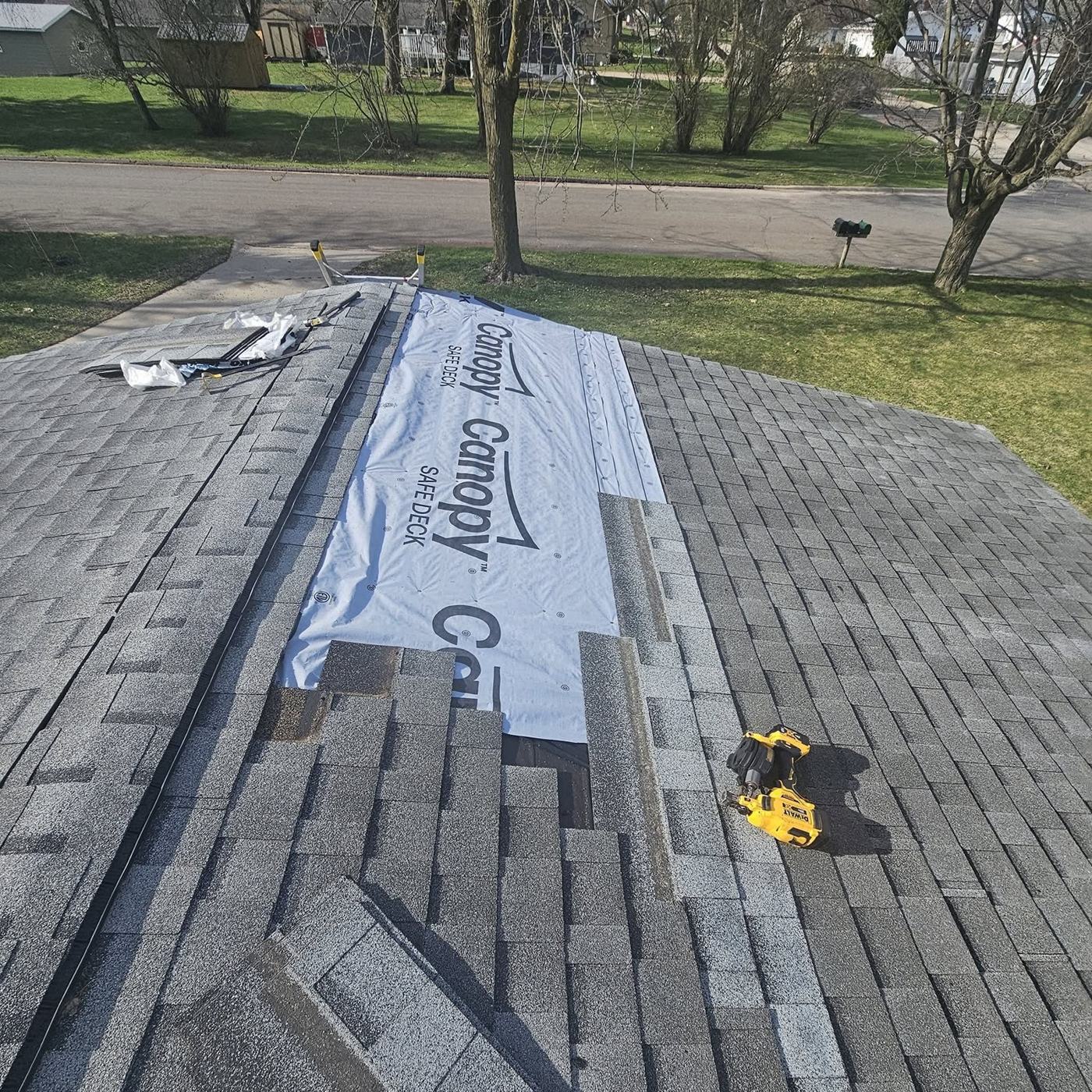 Shingles coming off a roof, with underlayment down